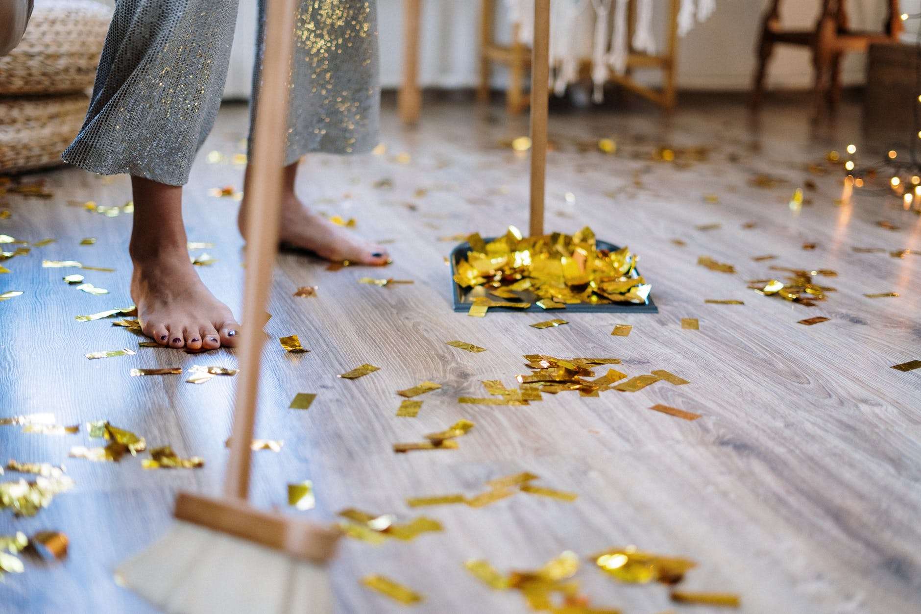 cover photo – person sweeping gold confetti