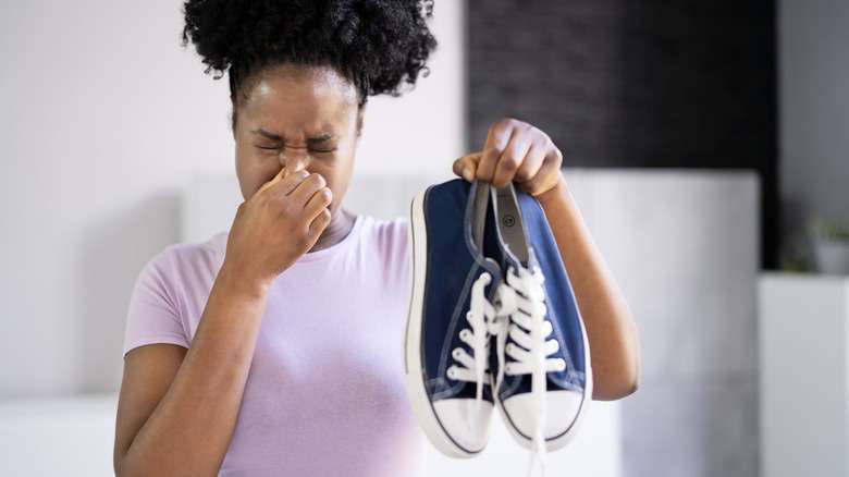 Close-up Of A Young Woman Holding Stinky